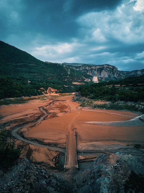 A river runs through a valley with a mountain in the background.