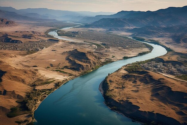 a river runs through a valley with mountains in the background