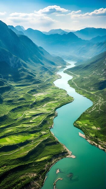 a river runs through a valley with mountains in the background