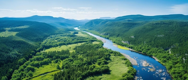 a river runs through a valley with mountains in the background