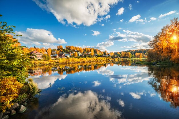 The river Shokhonka in the autumn Plyos and the classic view of the houses with reflection