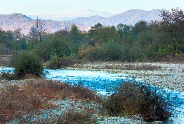 River view and autumn evening mountain behind.