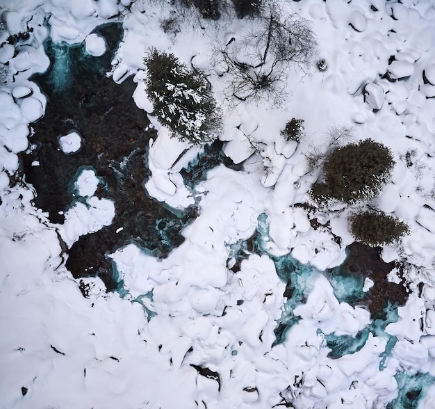 River in the winter forest top view