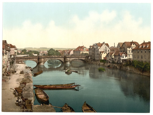 a river with a bridge and a boat in it