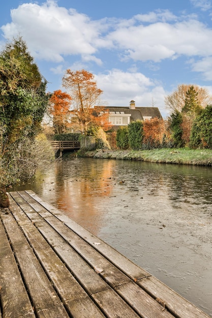 A river with a bridge and a house in the