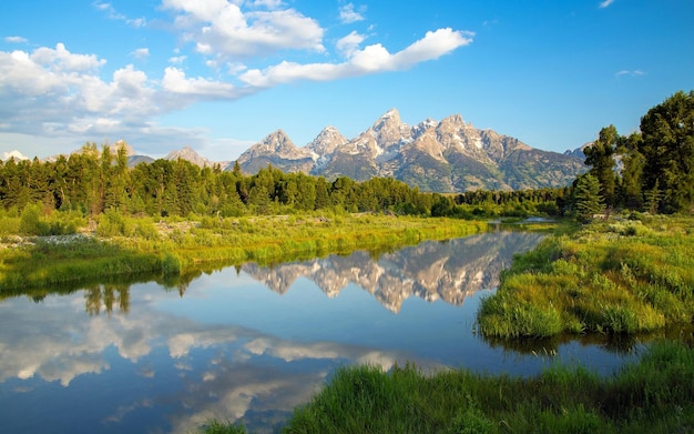 a river with a mountain in the background and a mountain in the background