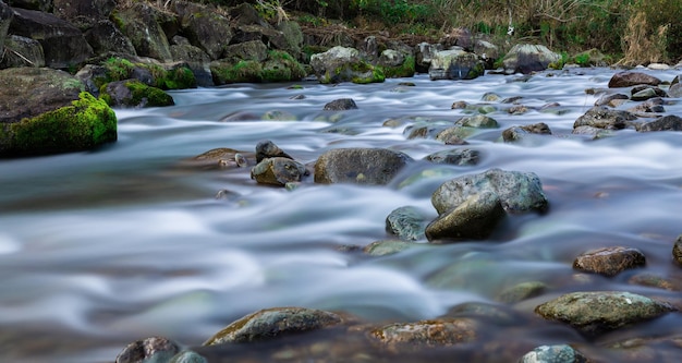 A river with rocks and water flowing in the distance