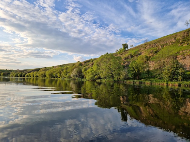 A river with trees and hills in the background