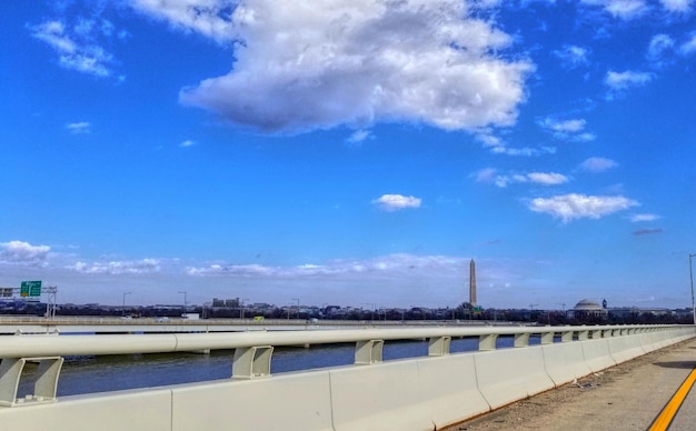 Road against blue sky in city