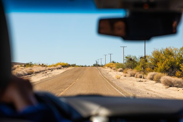 Road against clear sky seen through car windshield