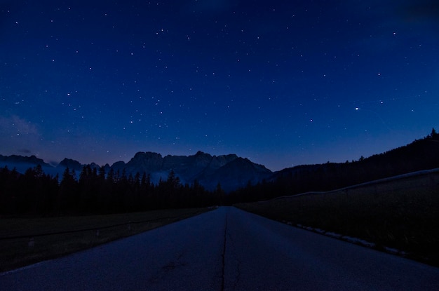 Road against sky at night