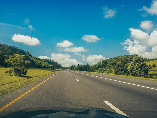 Road against sky seen through car windshield