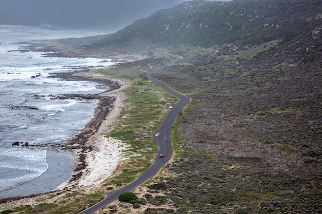 Road along the mountains and the Indian Ocean in Cape Town