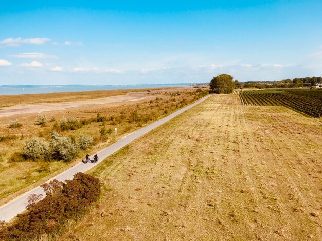 Photo road amidst field against sky  burgenland neusiedlersee