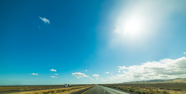 Road amidst land against sky