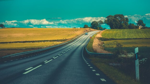 Road amidst landscape against sky