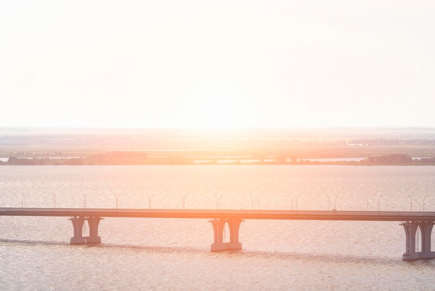 Road bridge across the river at sunset or sunrise