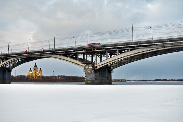 Road bridge over the river in winter