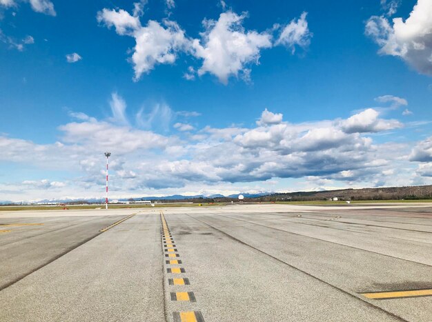 Road by airport against sky