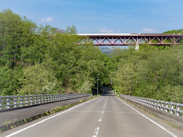 Road by bridge against sky