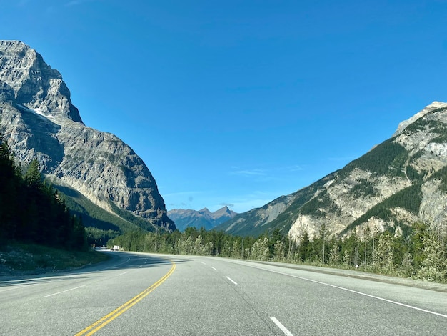 Road by mountain against sky