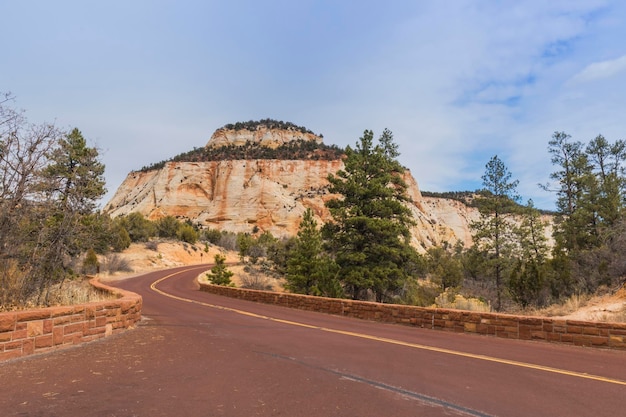 Road by rock formation against sky