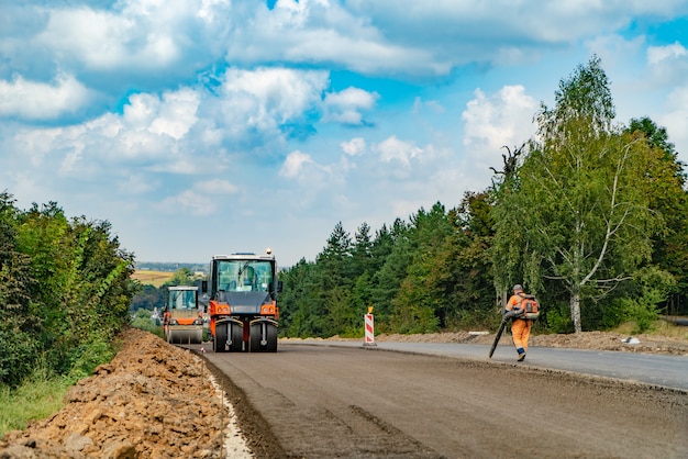 Дорожно-строительные работы с катком и асфальтоукладчиком