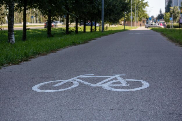 Photo road for cyclists with wheel stencil on asphalt