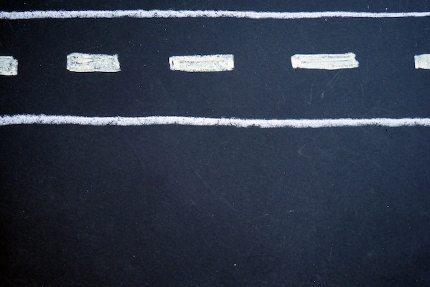 Photo road drawn by white chalk on black board