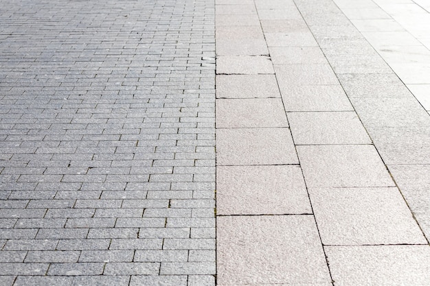 The road is paved with gray stones, top view. stone texture, outdoor stone tiles