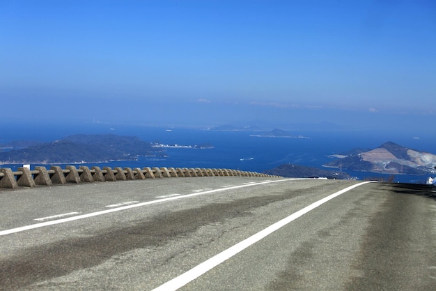 Road leading towards mountain against sky