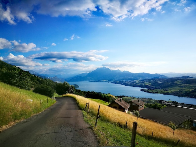 Road leading towards mountains against sky