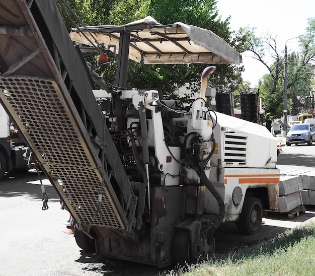 Photo road milling machine on city street