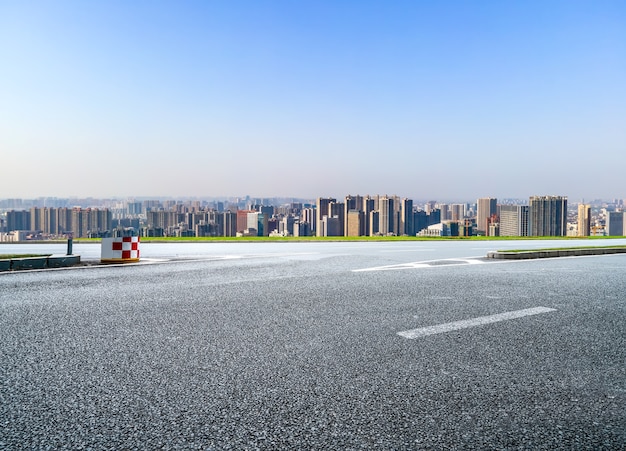 Road and modern city buildings background