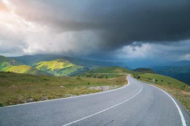 Road in mountain and deep rainy sky