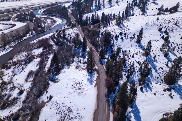 A road in the mountains with a river in the background