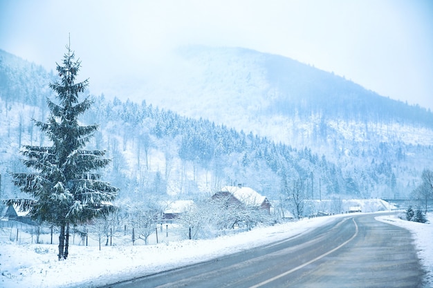 Road near mountain village in winter