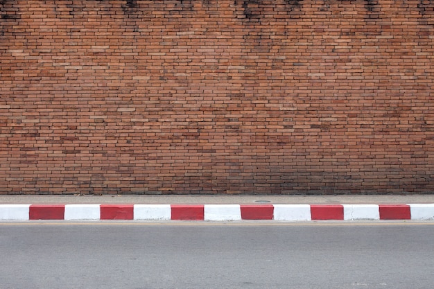 Road and old red brick wall texture