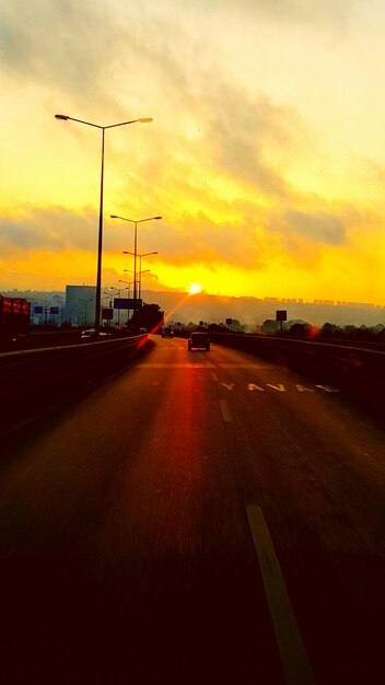 Road passing through dramatic sky