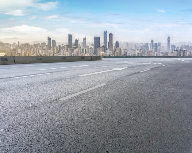 Road pavement and city skyline