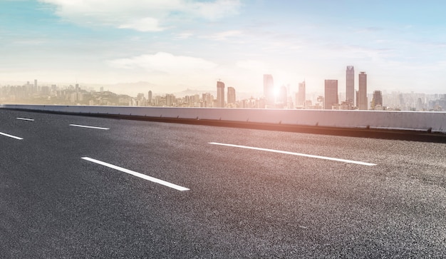 Road pavement and city skyline