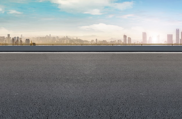 Road pavement and city skyline