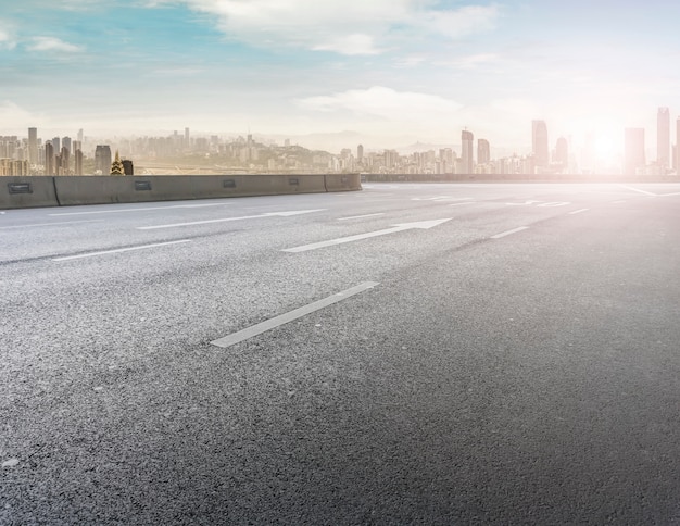 Road pavement and city skyline