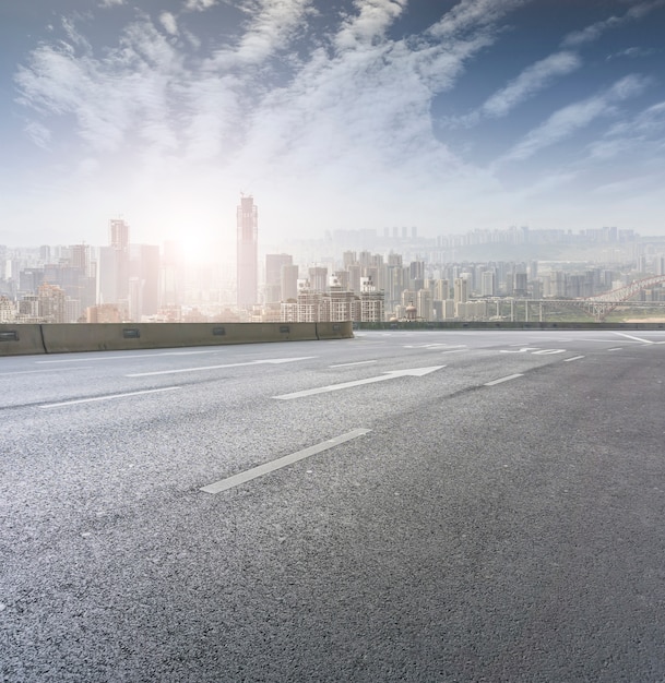 Road pavement and city skyline