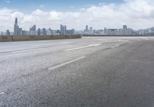 Road pavement and city skyline