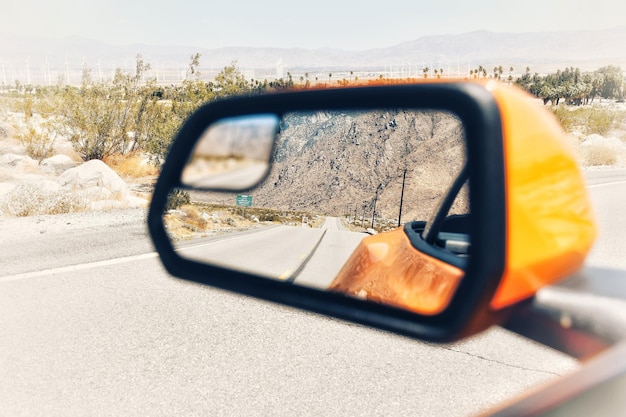 Foto riflessione della strada sullo specchio laterale di un'automobile