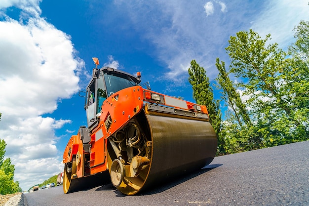 Road roller flattening new asphalt Heavy vibration roller at work paving asphalt road repairing Selective focus