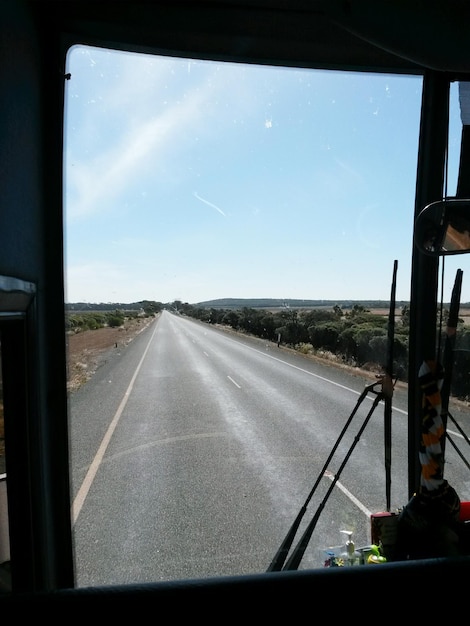 Photo road seen through bus windshield