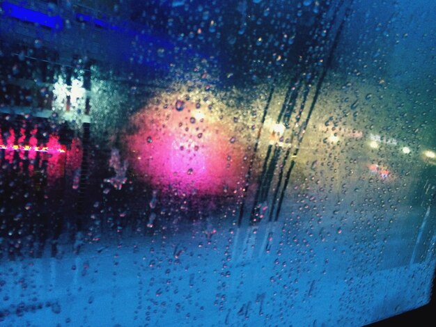 Road seen through wet glass window