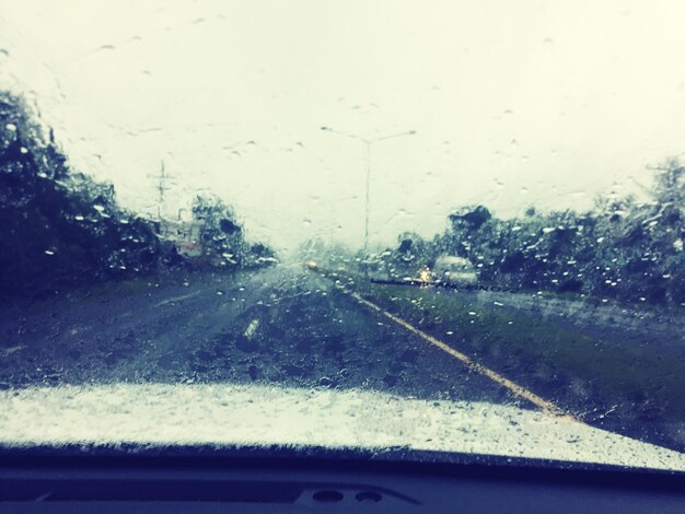 Road seen through wet windshield